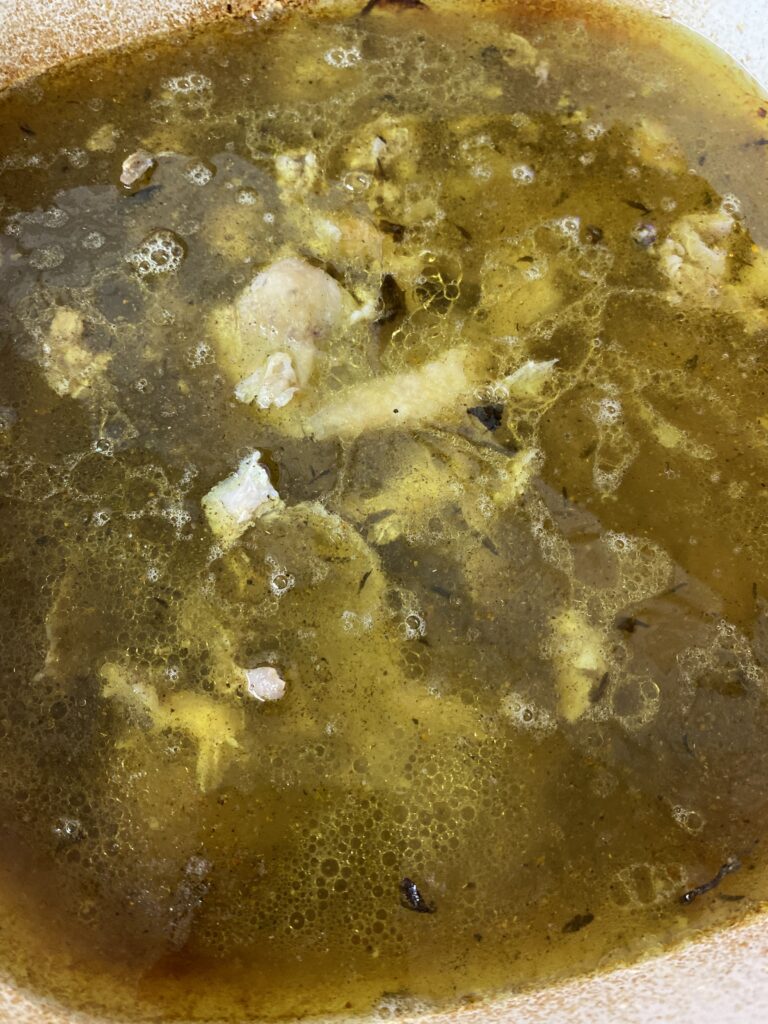 Chicken Bones and drippings in water in dutch oven