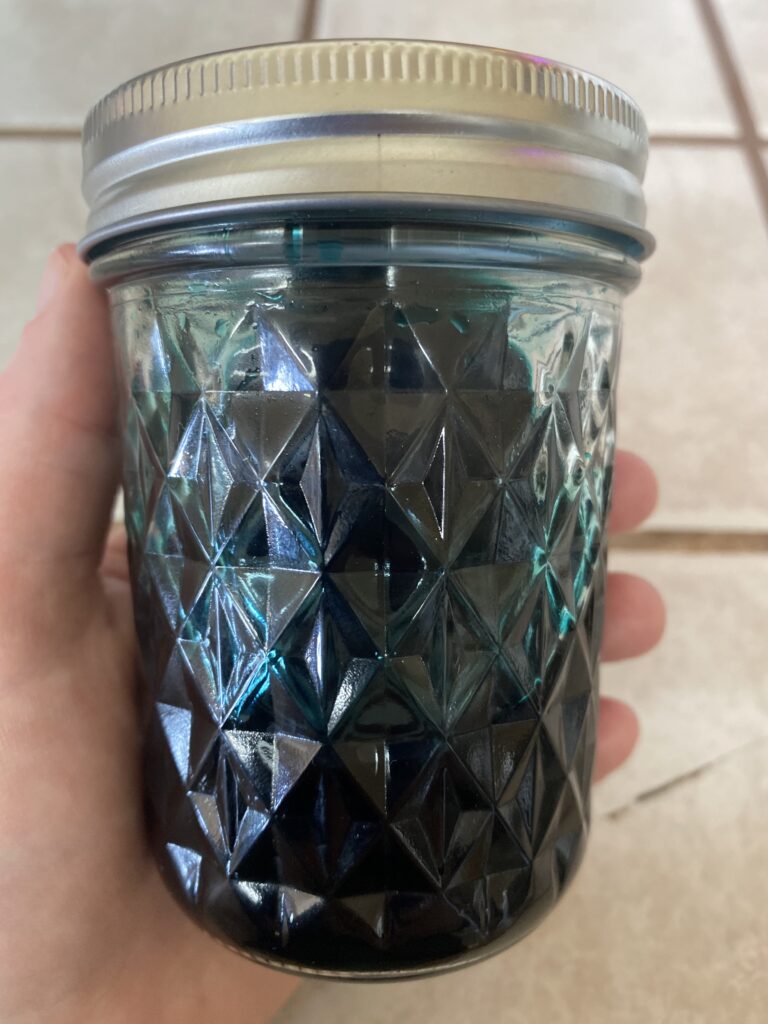 Mason jar of blue dye for Easter eggs